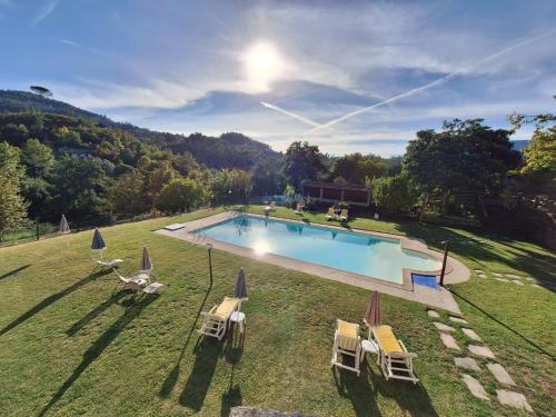 an aerial view of a swimming pool with chairs and umbrellas at Casa de Emaús - Gerês in Terras de Bouro