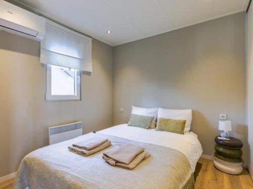 a bedroom with a large bed with towels on it at Casa Leon in Haarle