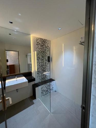 a bathroom with a sink and a mirror at WYNS Hotel Bandung in Bandung