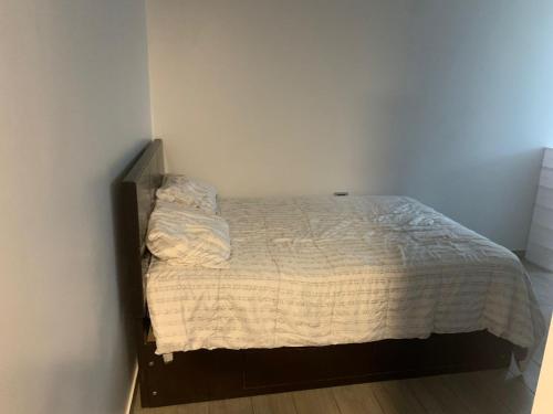 a small bed in a bedroom with a white bedspread at Acogedores pisos en el valle de Mala in Mala