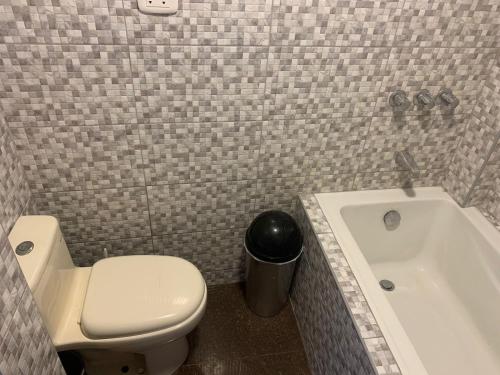 a bathroom with a toilet and a sink and a tub at Acogedores pisos en el valle de Mala in Mala