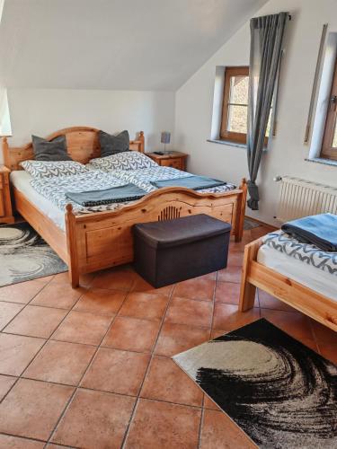a bedroom with a large wooden bed and a window at Landhaus am Brubbel in Wallenborn