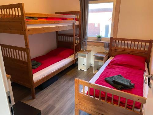 a bedroom with two bunk beds and a window at Traumhaus am See 2 in Rieden