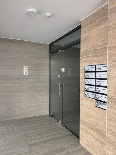 a walk in closet with a glass door at AFRODITI Living in Nicosia