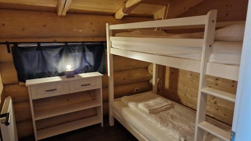 a room with two bunk beds and a tv at Chalet Marmotte am Nassfeld in Hermagor