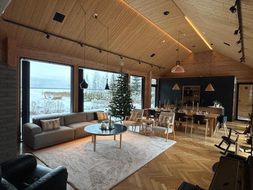 a living room with a couch and a table at Hulppea merenranta hirsitalo in Oulu