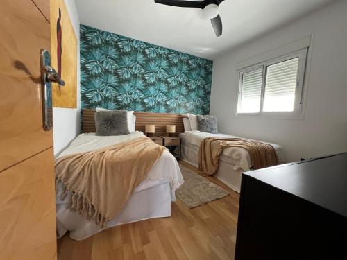 En eller flere senge i et værelse på Casita Agave