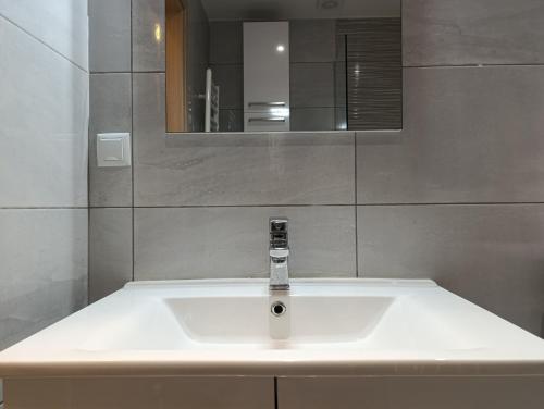 a white sink in a bathroom with a mirror at Molly Downtown Thessaloniki in Thessaloniki