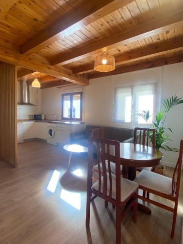 a kitchen and dining room with a table and chairs at La espiga de Segovia 2 in La Lastrilla