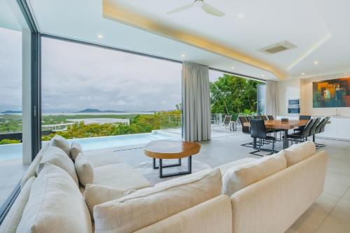 a living room with a couch and a table at Lapista 6 Bedroom Luxury Vila in Phuket