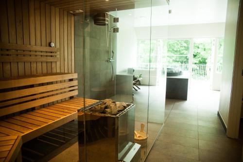 a room with a glass shower and a table at Bramslevgaard in Hobro