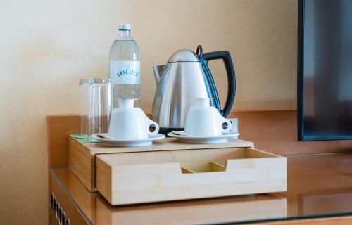 a blender and a bottle on top of a table at Ibercity Wien Schönbrunn in Vienna