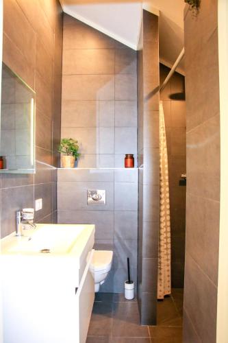 a bathroom with a toilet and a sink at Strandbries in Warmenhuizen