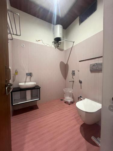 a bathroom with a toilet and a sink at The hotel Veshal In in Ayodhya