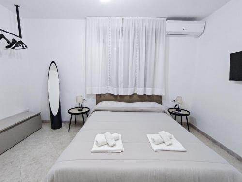 a bedroom with a bed with two towels on it at Dimora del Centro in Marsala