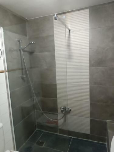a bathroom with a shower with a glass door at Apartamento SUMMER Complex Amaya Fuerteventura in Costa de Antigua