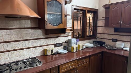 eine Küche mit Holzschränken und einer Arbeitsplatte in der Unterkunft Luxstay kochi in Kochi