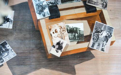 a group of photographs on the floor of a room at Amymone and Adiandi in Nafplio