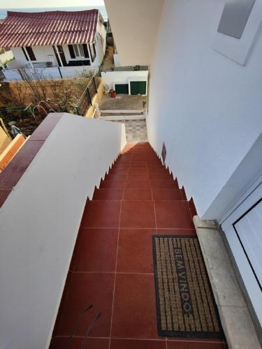 a stairway with a red tile floor in a building at Blife Petrya private rooms at Faro beach in Faro