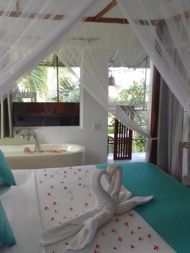 a bedroom with a bed with a heart made out of towels at PEACEFUL GREEN VILLA in Unawatuna