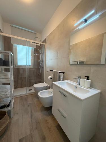 a bathroom with a white sink and a toilet at MH Lippolis in Bari