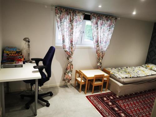 a small room with a desk and a bed and a desk at Nordic Elegance Villa in Uddevalla