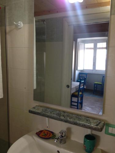 a bathroom with a sink and a mirror at La Casa di Titina in Procida
