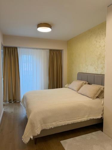 a bedroom with a large bed and a window at Palata Royal Banja Luka Luxury Apartment in Banja Luka