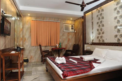 Postel nebo postele na pokoji v ubytování Sonar Bangla's Motel Midway