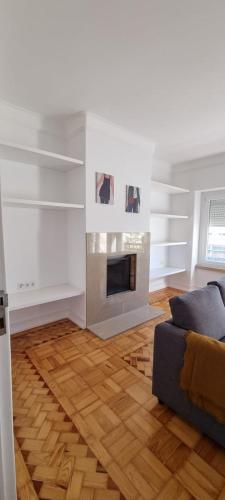 a living room with a fireplace and a couch at Rio de Janeiro 26 in Lisbon