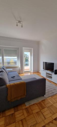 a living room with a bed and a television at Rio de Janeiro 26 in Lisbon