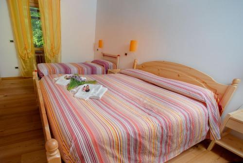 a bedroom with a bed with a tray of food on it at Albergo Diffuso Dolomiti in Forni di Sotto