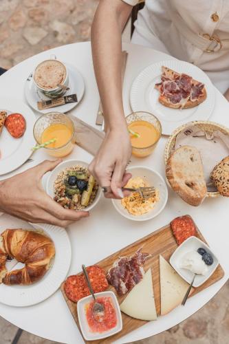 a table with a lot of food on it at Hotel Can Cirera in Palma de Mallorca