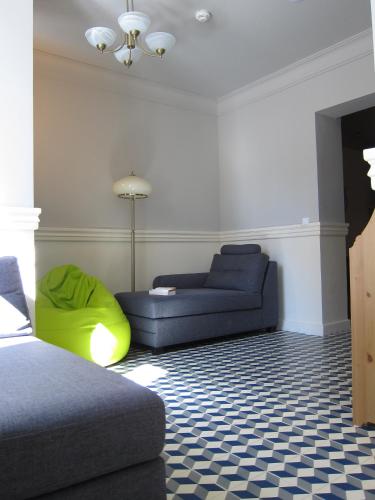 a living room with a blue couch and a green couch at Hostel Wratislavia in Wrocław