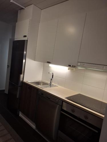 a small kitchen with a sink and a refrigerator at Starvillas B201 in Kalajoki