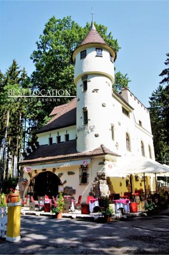 a building with a lighthouse on top of it at Rezidence Zámeček - Boutique Hotel in Františkovy Lázně