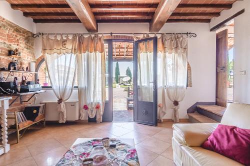 a living room with a couch and a door at Il Podere - Rustic Charm in Tuscany in Monte San Savino