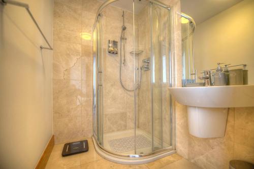 a bathroom with a shower and a sink at Tur an Tsaile - Galway Lakeside Apartments in Galway