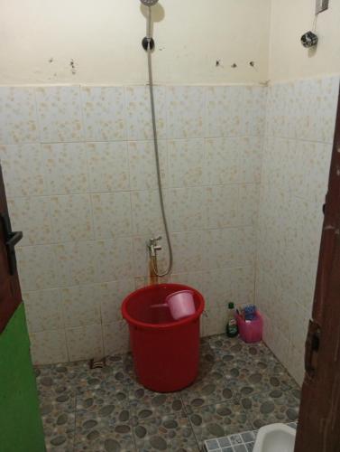 a bathroom with a bucket in the corner of a shower at sarisare homestay 2BR in Bulakbenda