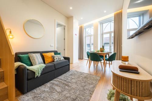 a living room with a couch and a table at Casa da Cónega by Sé Apartamentos in Braga