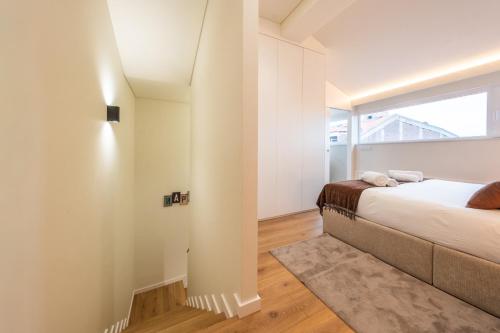 a bedroom with a bed and a window at Casa da Cónega by Sé Apartamentos in Braga