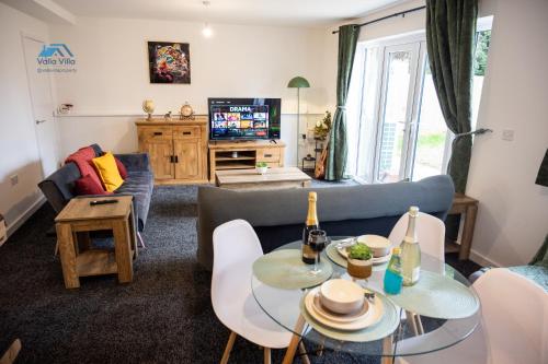 a living room with a couch and a table at Pines Villas 1, Three Spacious 3BR Homes, Perfect for Groups in Boughton
