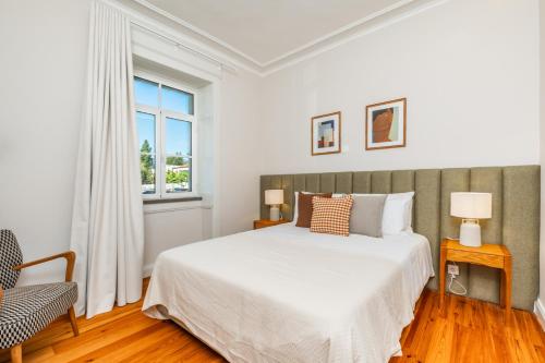 a white bedroom with a bed and a window at Quintinha de São Martinho - Villa & Lux in Funchal