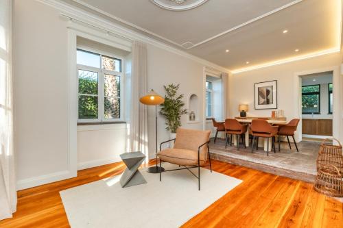 a living room with a table and chairs at Quintinha de São Martinho - Villa & Lux in Funchal