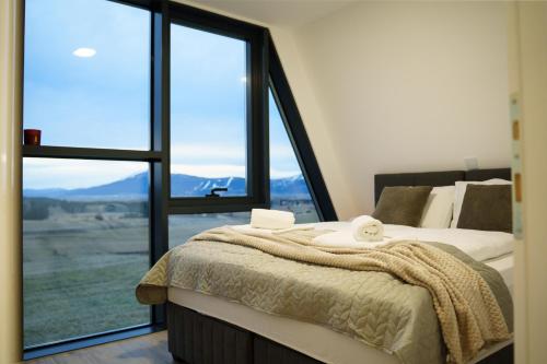 a bedroom with a bed and a large window at The Sky Hill - luxury chalet in Kupres