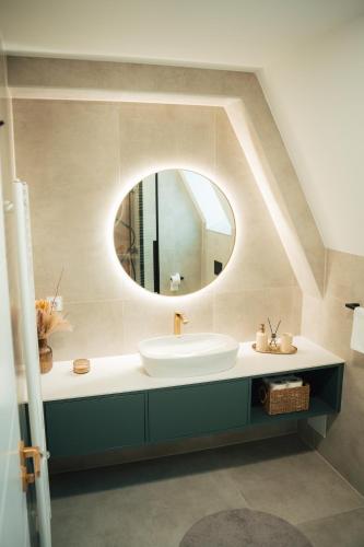 a bathroom with a sink and a mirror at The Sky Hill - luxury chalet in Kupres