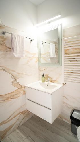 a bathroom with a white sink and a mirror at Pension Saphir in Bistriţa