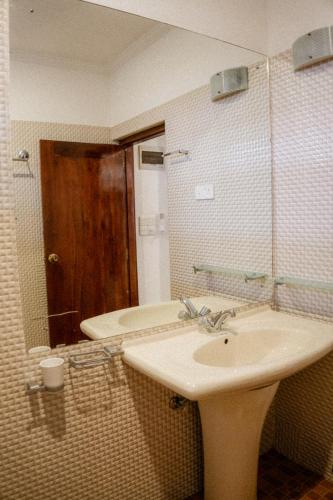 a bathroom with a sink and a mirror at Beach House Goviyapana in Ahangama