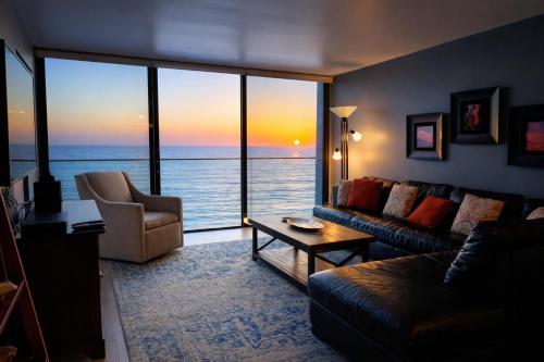a living room with a view of the ocean at Ocean View Luxury Condo Oceanfront and Pool in San Diego