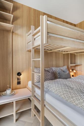 a small bedroom with bunk beds and a desk at NEW! High end cabin Lofoten 4 in Lyngværet